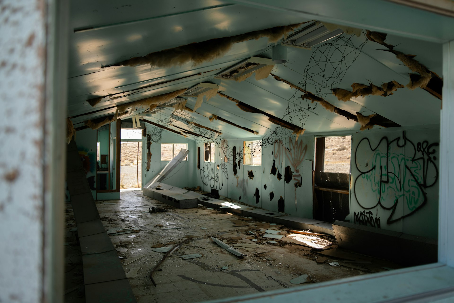 a run down building with graffiti on the walls